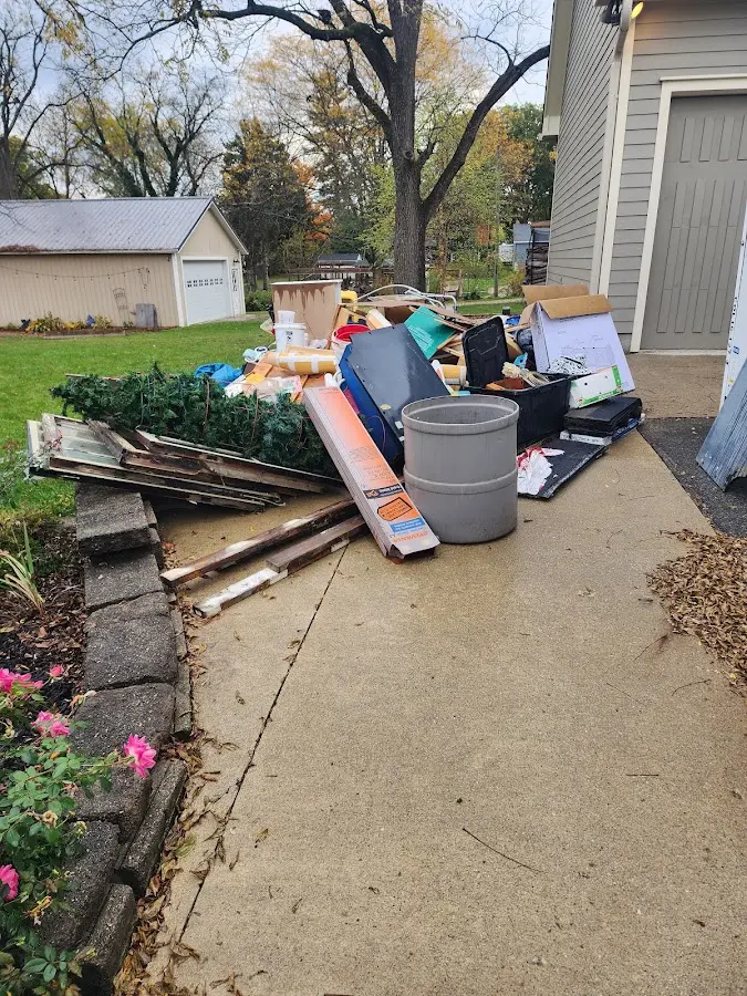 Dumpster being loaded with debris for Residential Dumpster Rental in Collegedale